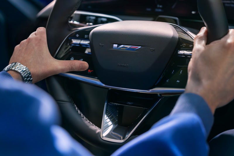 Close-up of a Man About to Press the V-Button on the 2026 OPTIQ-V Steering Wheel | Devan Lowe Buick Cadillac GMC in RAINBOW CITY AL