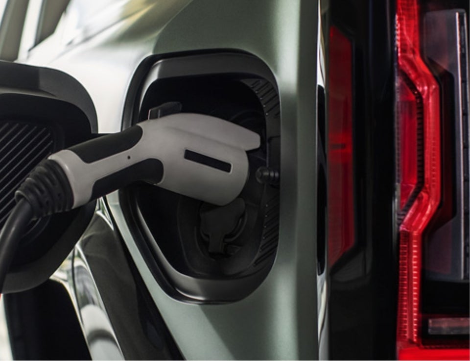 Close up of charging port with charger plugged in on a GMC Hummer EV SUV - Devan Lowe Buick Cadillac GMC in RAINBOW CITY AL